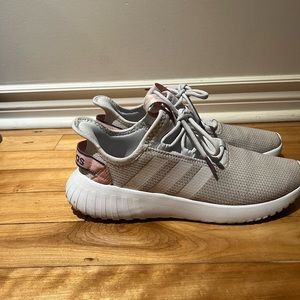 Adidas women’s running shoe in light grey, white and pink.